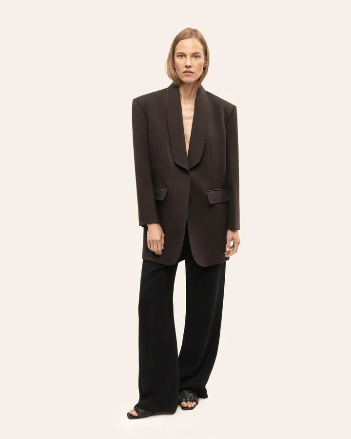 Wide black trousers worn with the jacket